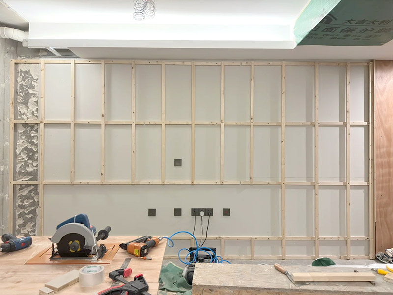 Install the wooden brackets first, then install the wall panels.