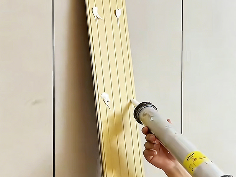 Install wall panels using adhesive